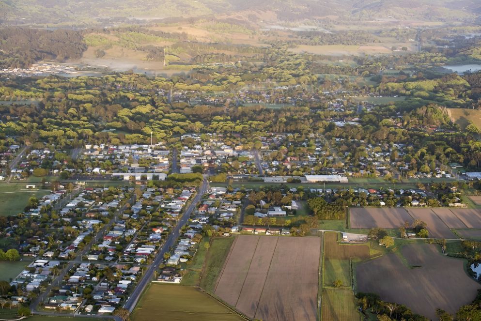 An Aerial View of a Small Town Surrounded by Fields and Trees — Goonellabah Roof Tilers In Mullumbimby, NSW