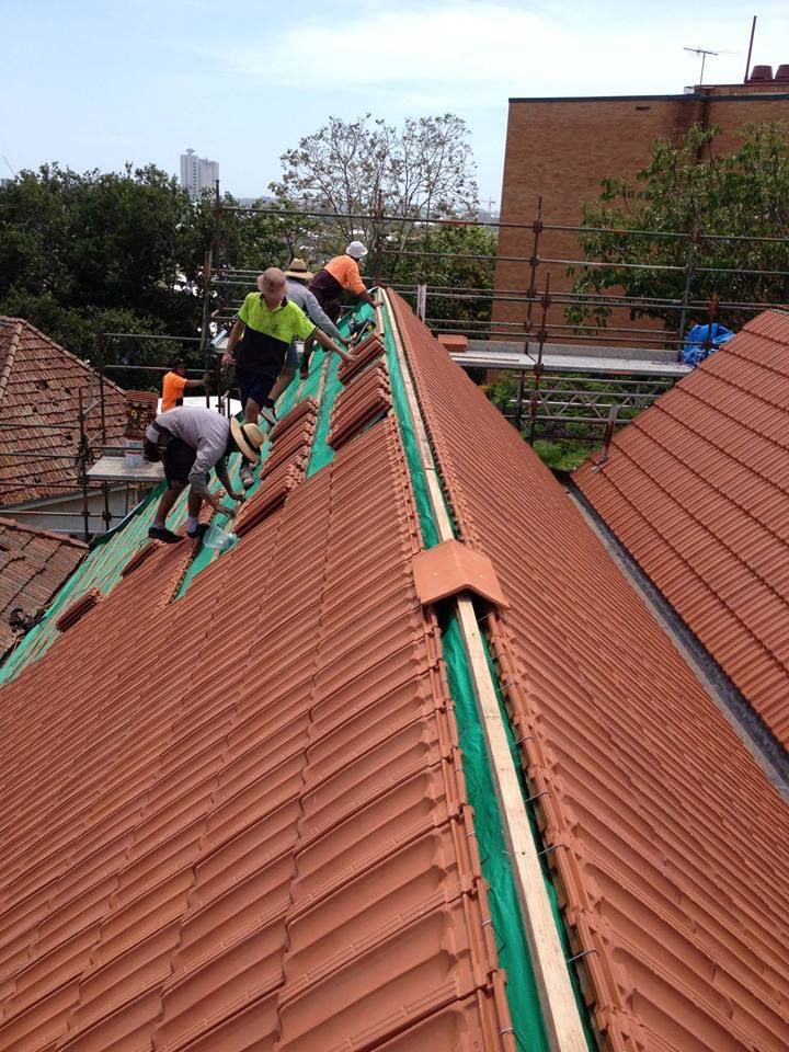 Roofers on a Roof Working on Adding Roof Tiles — Goonellabah Roof Tilers In Monaltrie, NSW