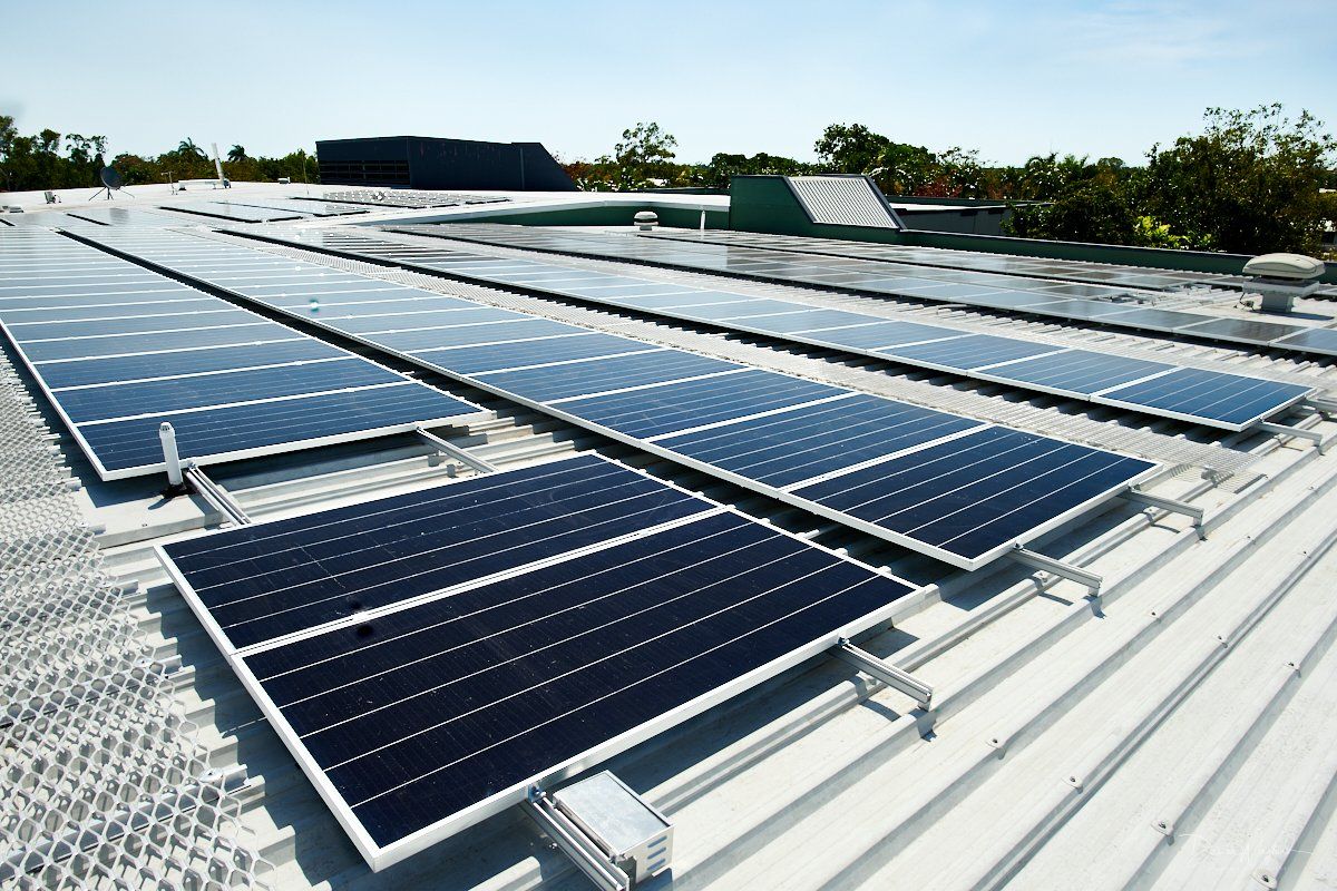 a row of solar panels on the roof of a building