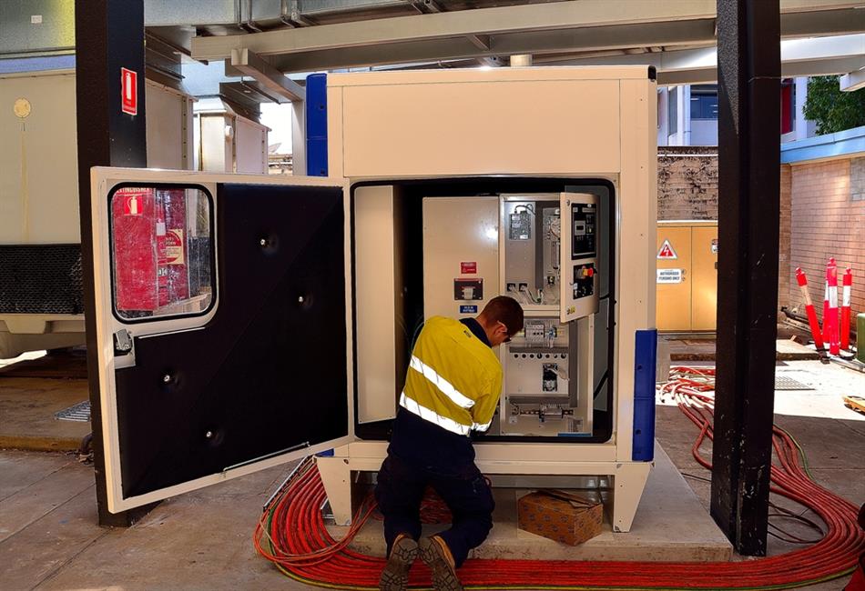 a man is working on a machine with the door open