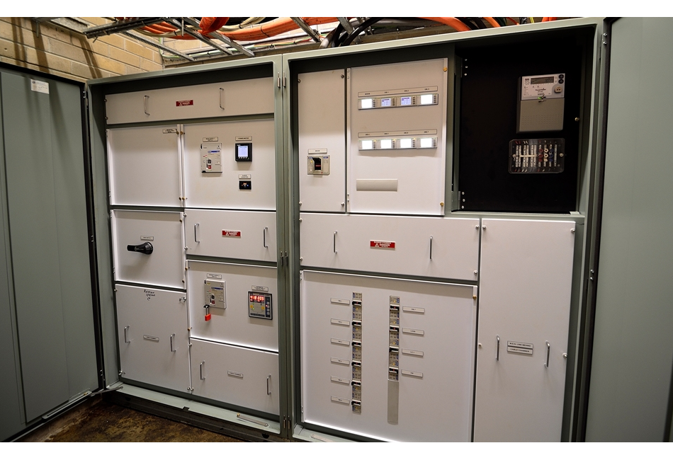a large electrical panel with a lot of electrical equipment on it .