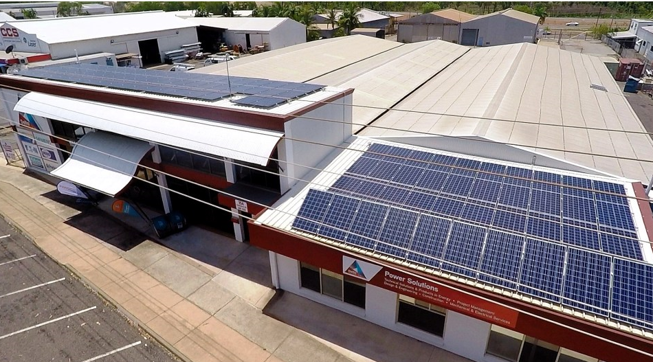 an aerial view of a building with solar panels on the roof
