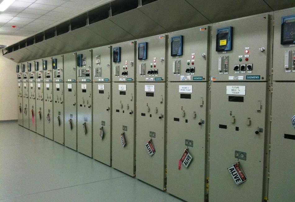 a row of electrical cabinets in a room with a sign that says atm