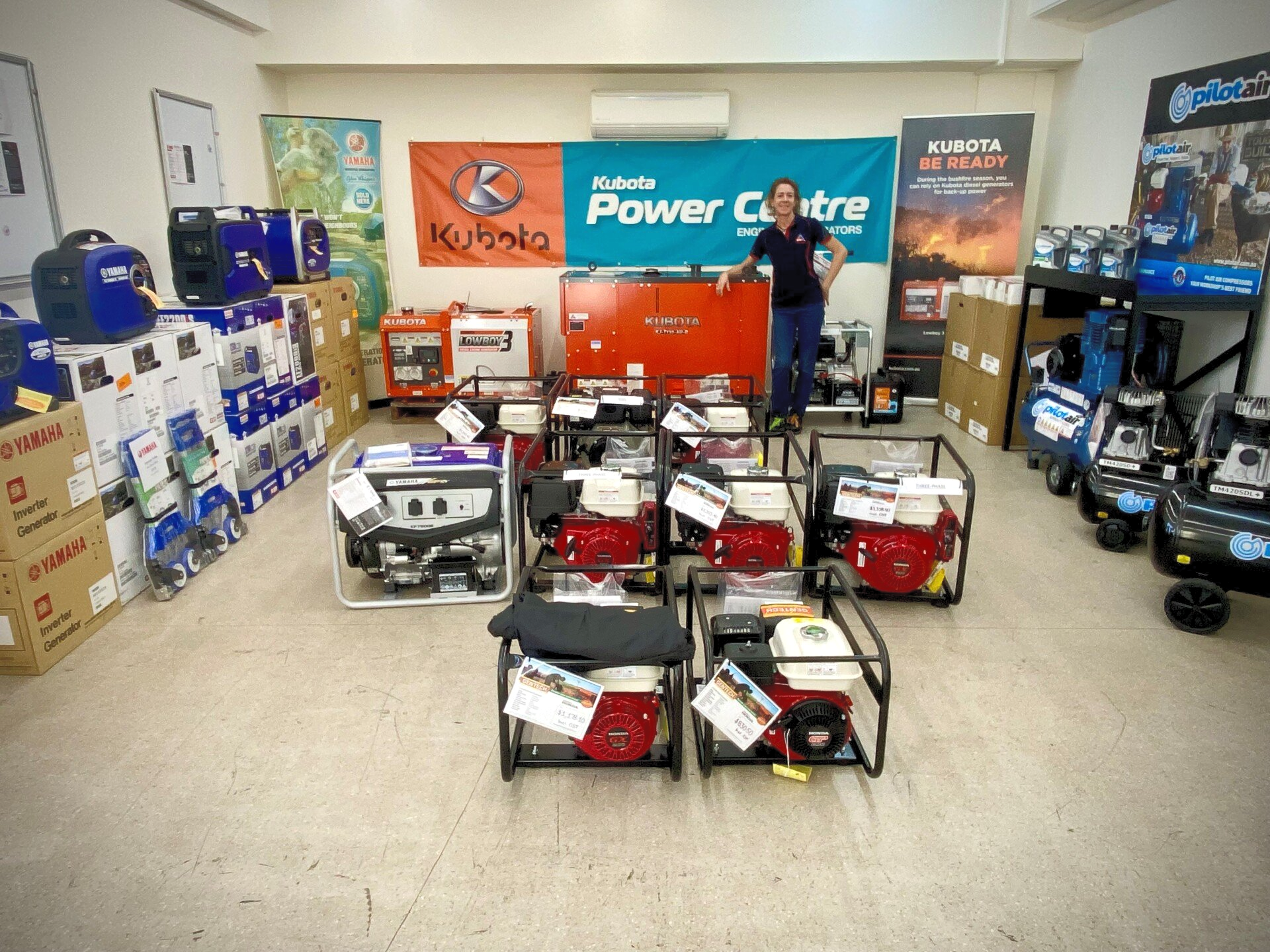 a man is standing in a room filled with lots of generators .