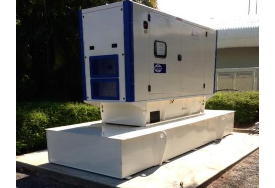 a white and blue generator is sitting on top of a concrete platform .