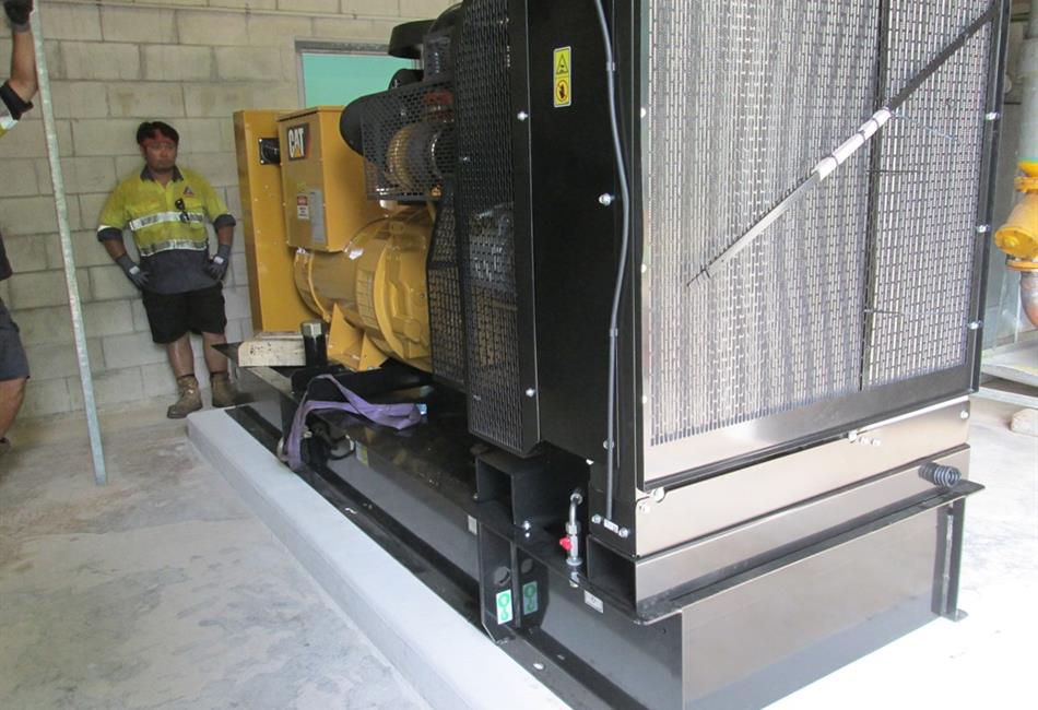 a man is standing next to a large yellow generator