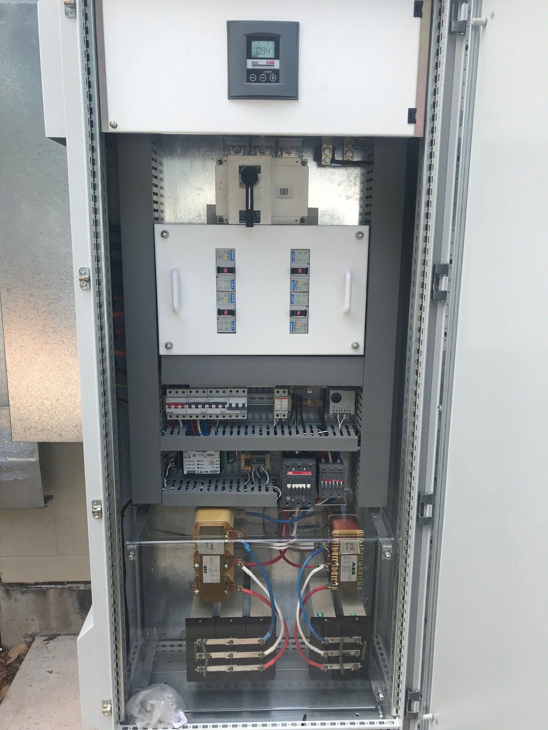 the inside of a electrical box with a lot of wires coming out of it .