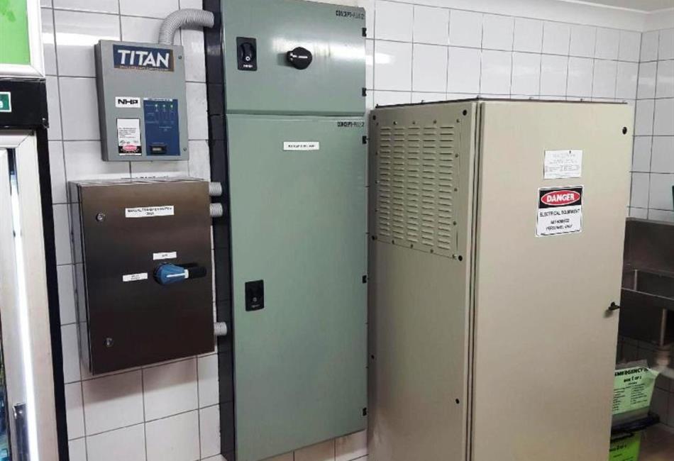 a kitchen with a titan electrical box on the wall