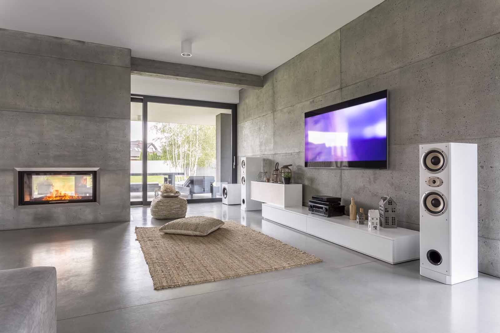 A living room with a flat screen tv and speakers.