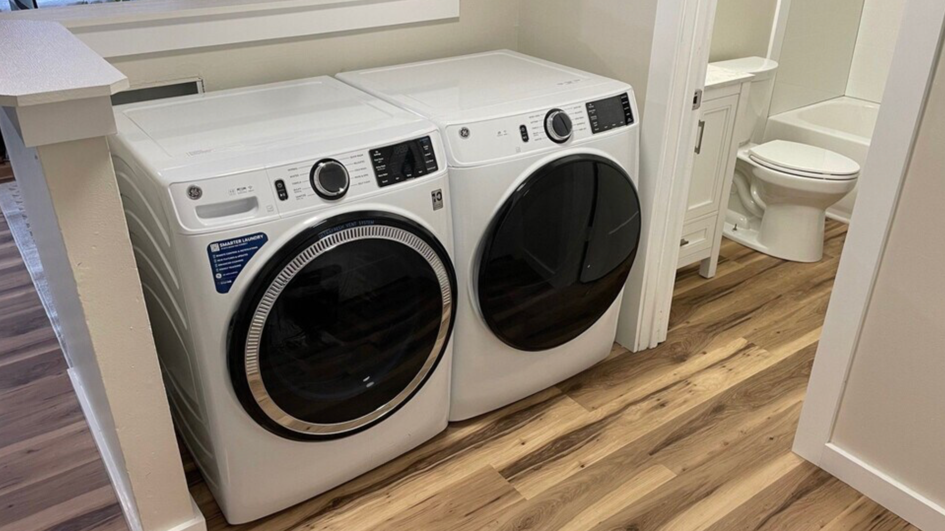 A washer and dryer are sitting next to each other in a laundry room.