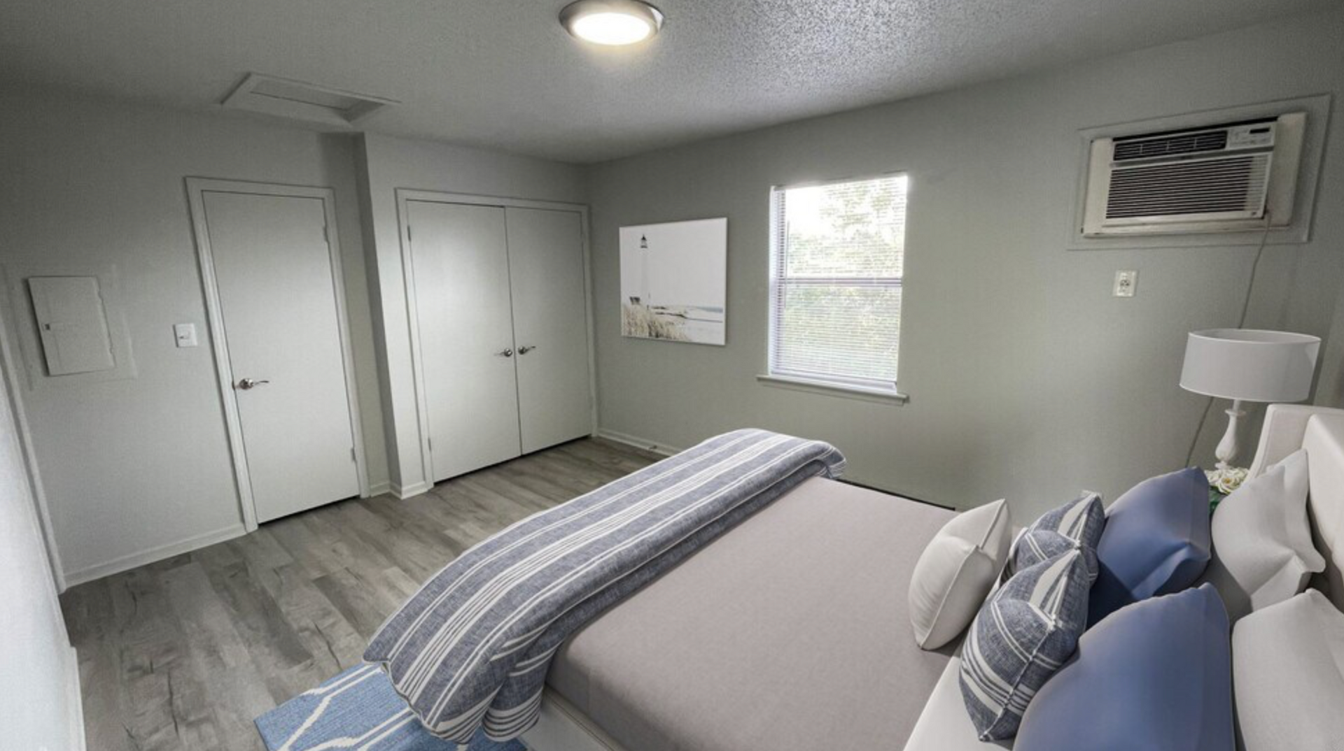 A bedroom with a large bed and a window.