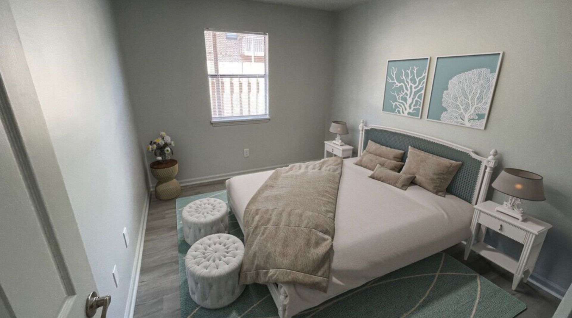 A bedroom with a bed , nightstands , ottomans and a window.