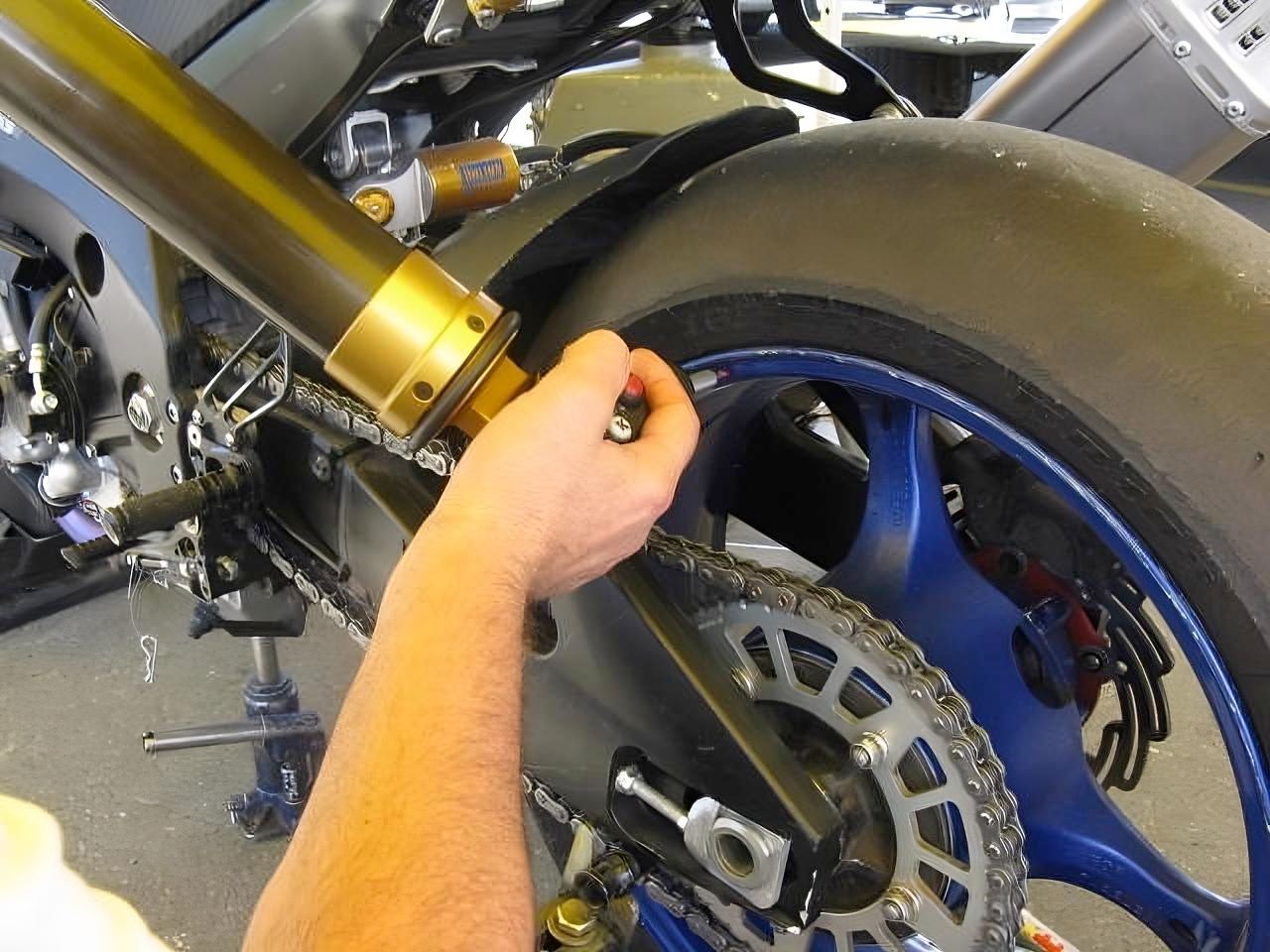 A person is working on a motorcycle in a garage