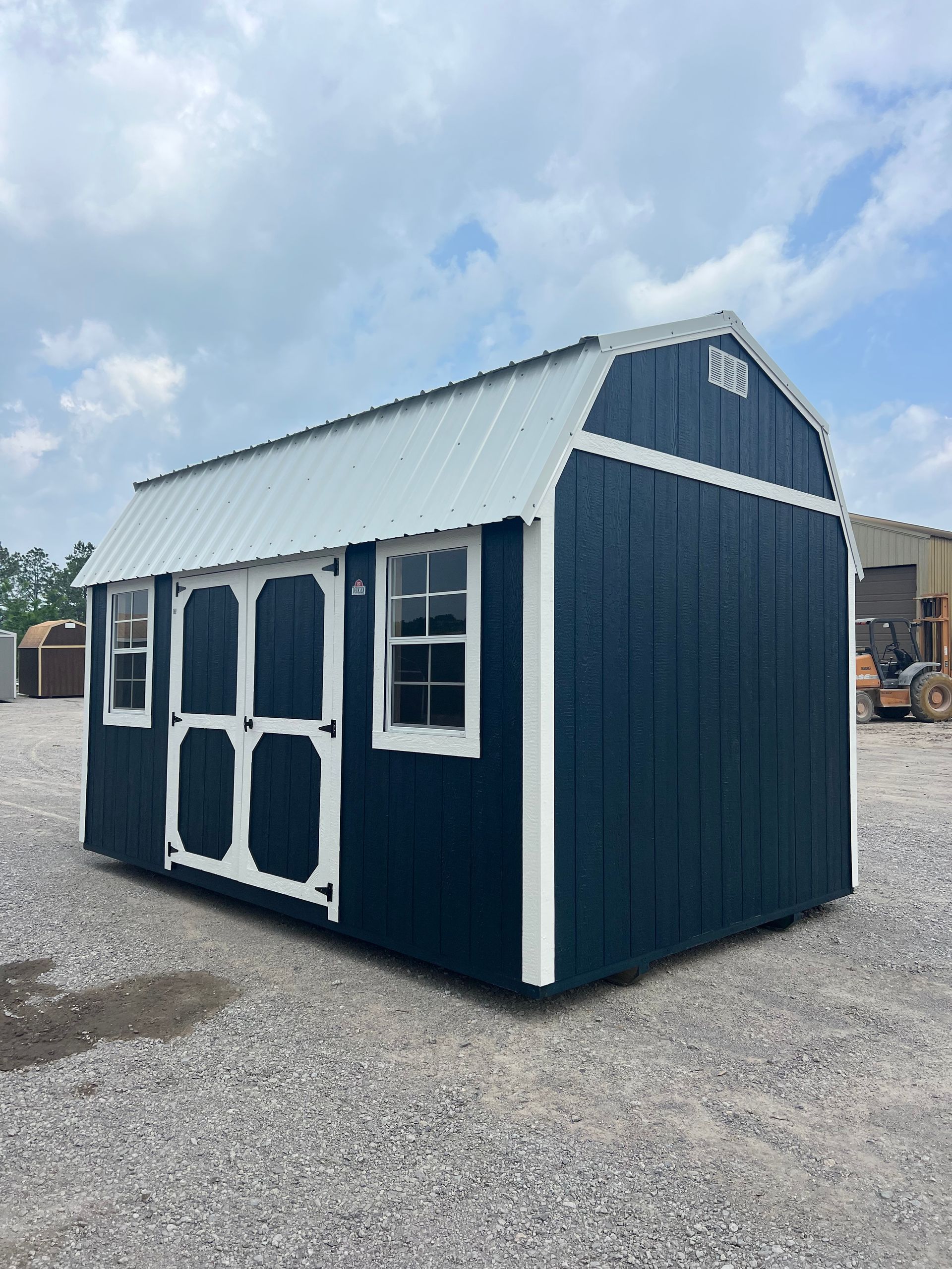 Explore the Derksen 10X16 Side Lofted Barn with Midnight Blue Paint, Alamo White Metal roof, and White Paint trim. Perfect for storage or a cozy retreat!