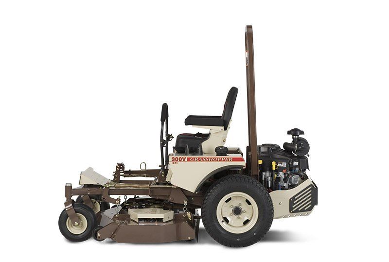 a brown and white lawn mower with the word grasshopper on the side