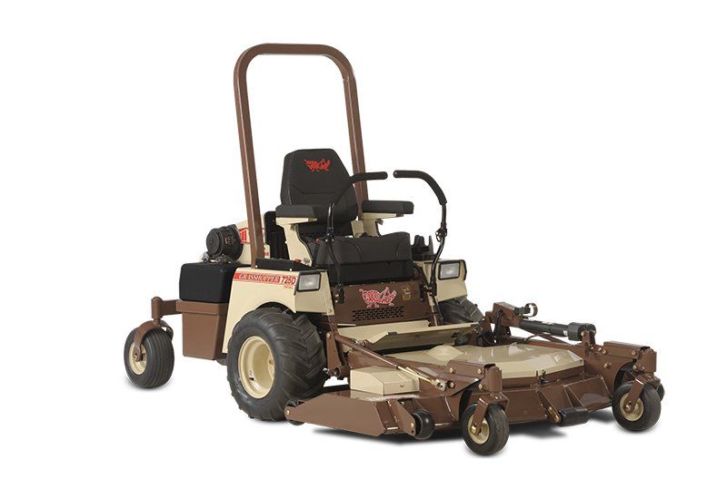 a brown and tan lawn mower with the word gator on it