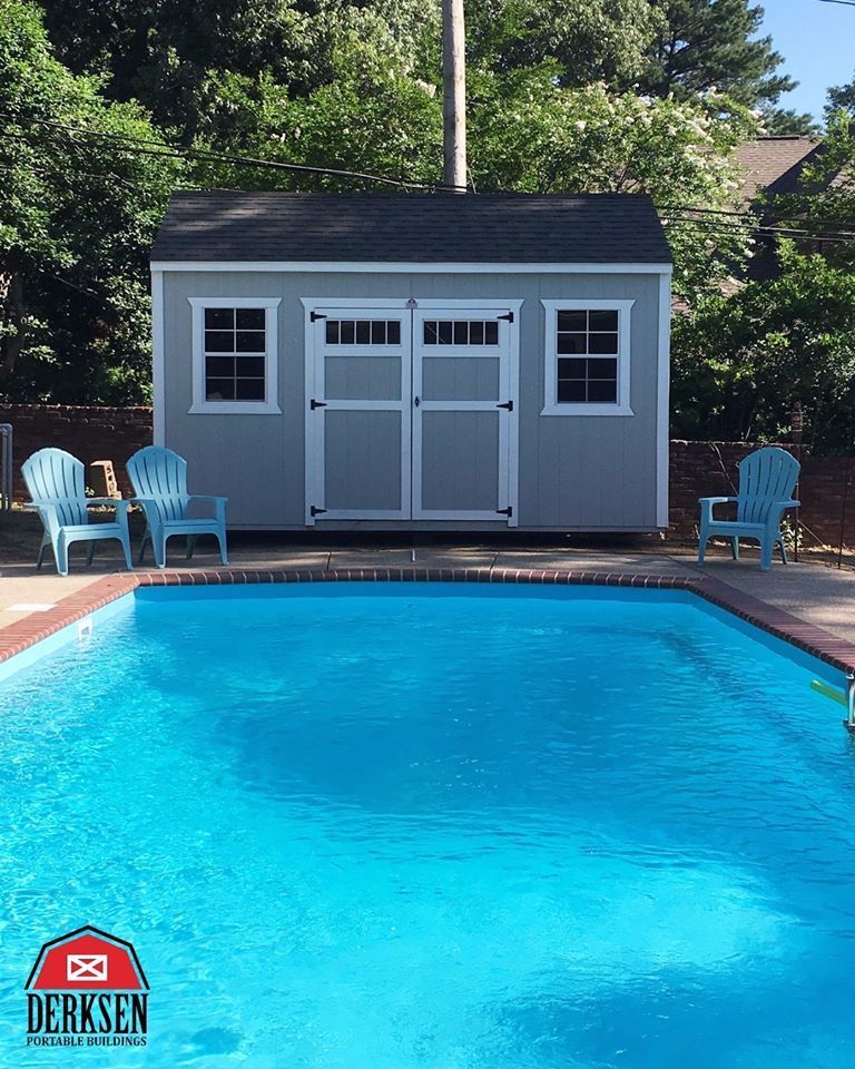 A shed sits next to a large swimming pool