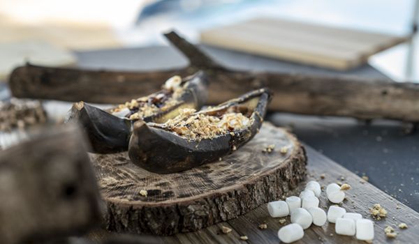 A close up of a piece of food on a wooden cutting board.