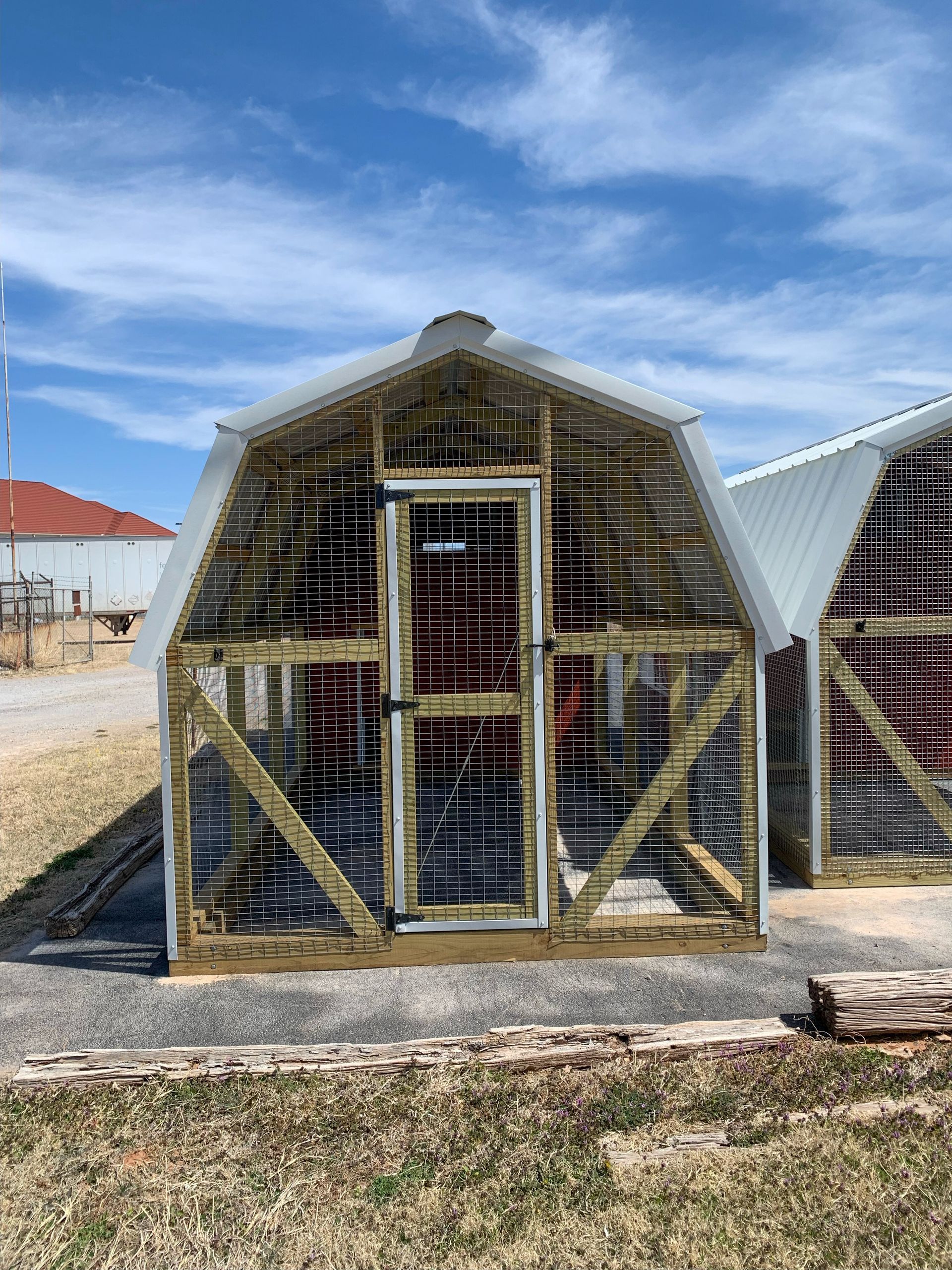 a 8 x 20 red chicken coop with a white roof