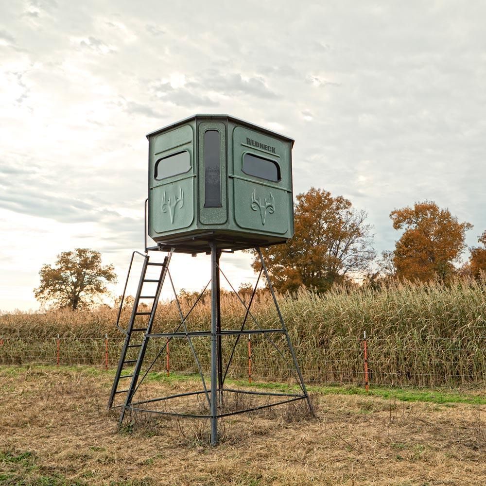 A deer stand in a field with a ladder attached to it.