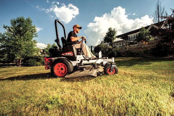 a bobcat tractor is loading rocks into a bucket