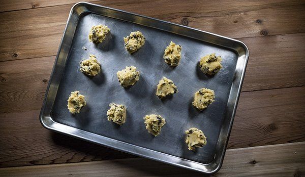 A pan filled with cookie dough on a wooden table.