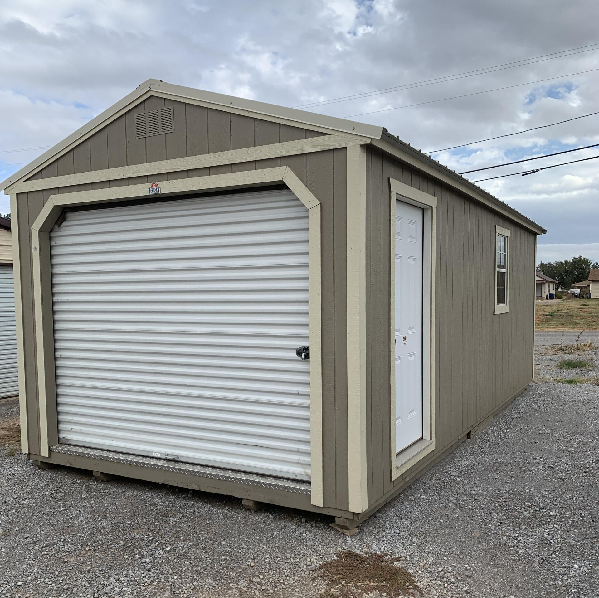 A small portable garage with a garage door and a window.