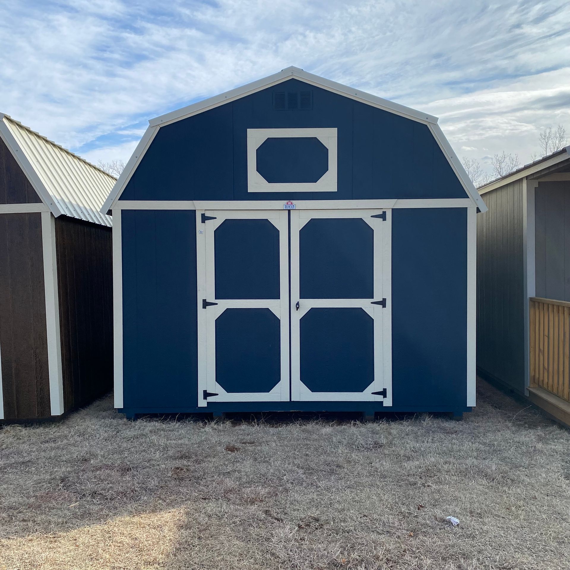 Front of 12x20 Portable Barn Navy Blue Siding With White Trim and Roof