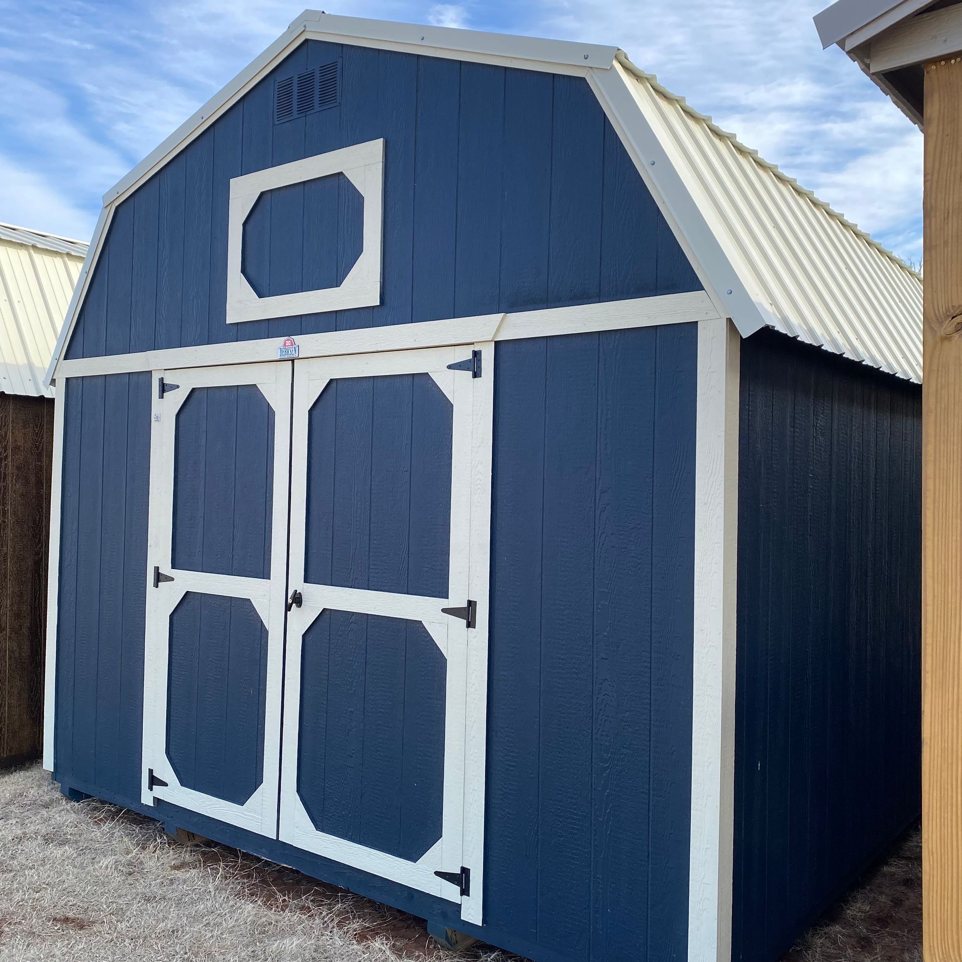 Front Side Angle Of 12x20 Portable Barn Navy Blue Siding With White Trim and Roof