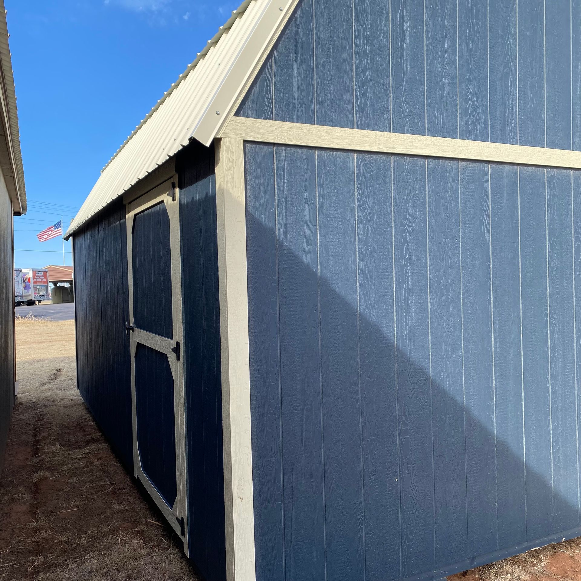 Extra Shop Door on 12x20 Portable Barn Navy Blue Siding With White Trim and Roof