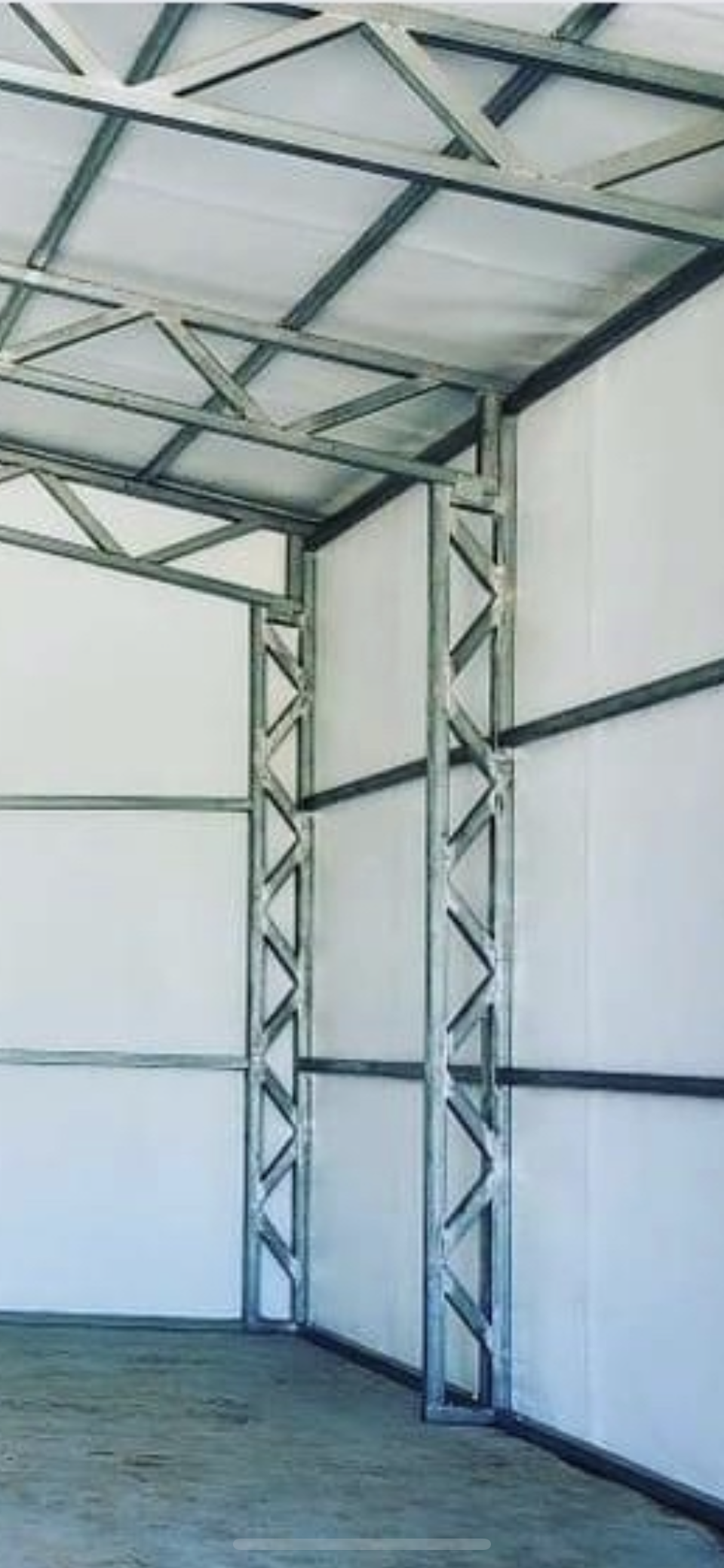 the inside of a garage with a metal frame and white walls .
