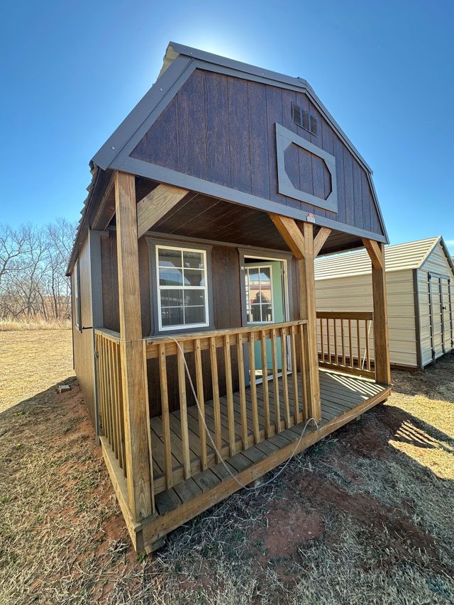 Explore the Used 12x16 Derksen Lofted Barn Cabin with electrical