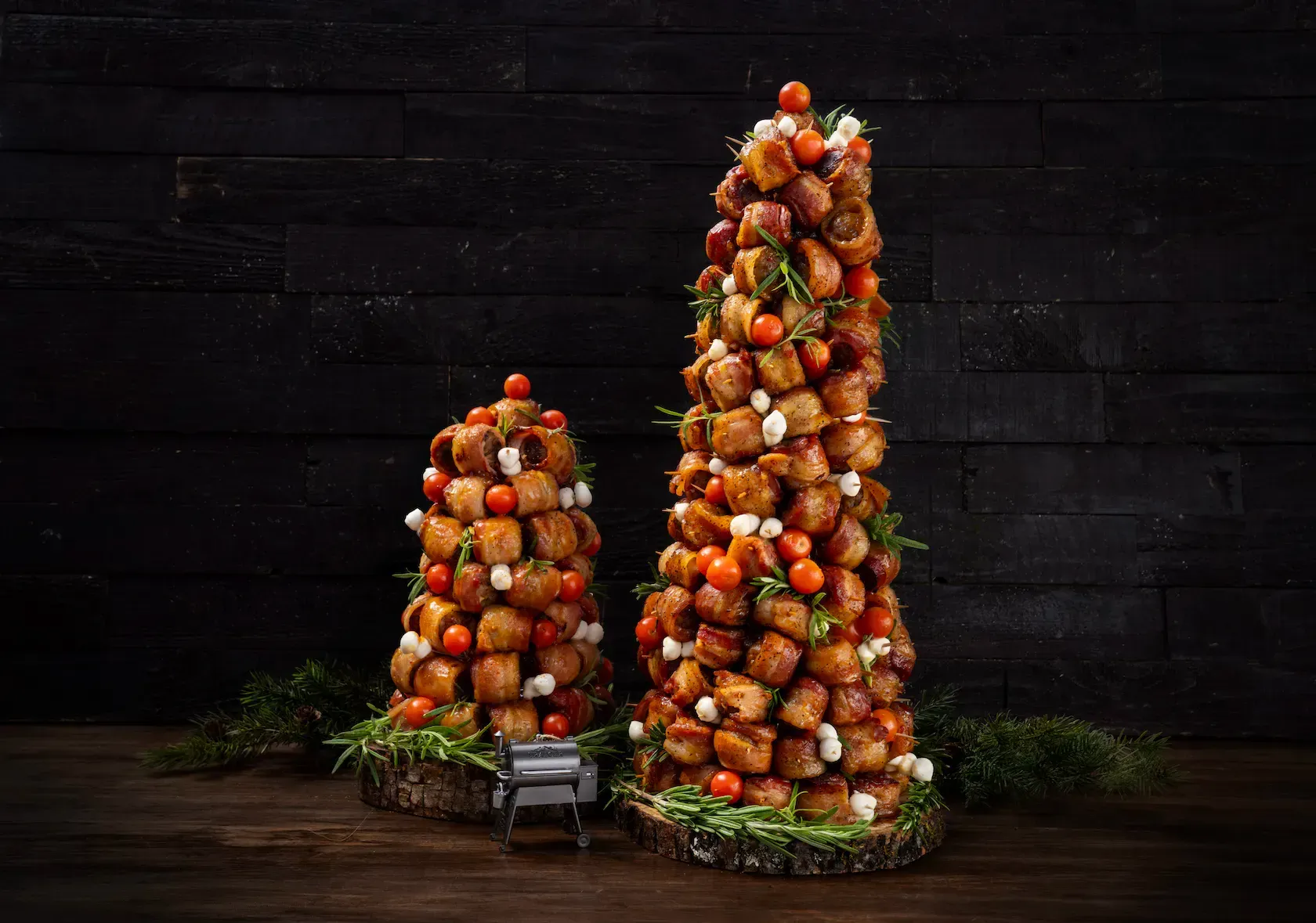 Two christmas trees made of food are sitting on a wooden table.