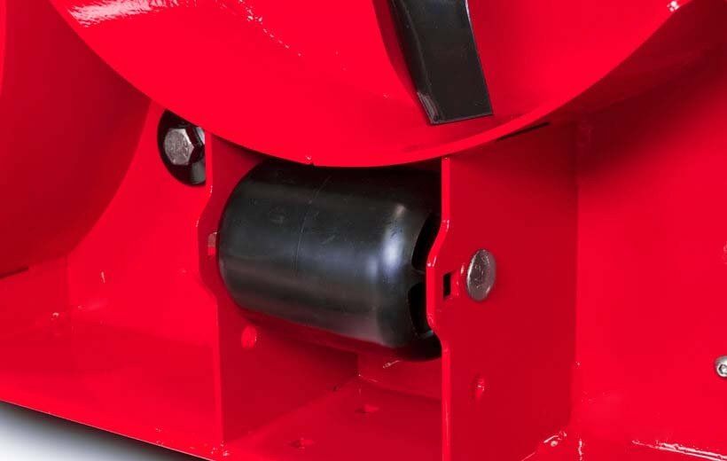 A close up of a red object with a black wheel on it.