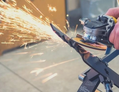a person is grinding a piece of metal with sparks coming out of it