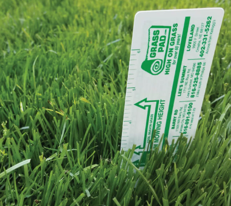 A ruler that says grass pad on it