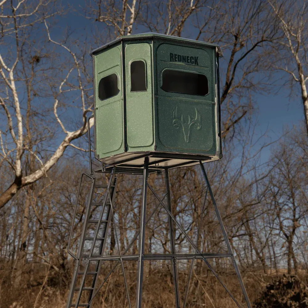 a green redneck tower in the middle of a forest