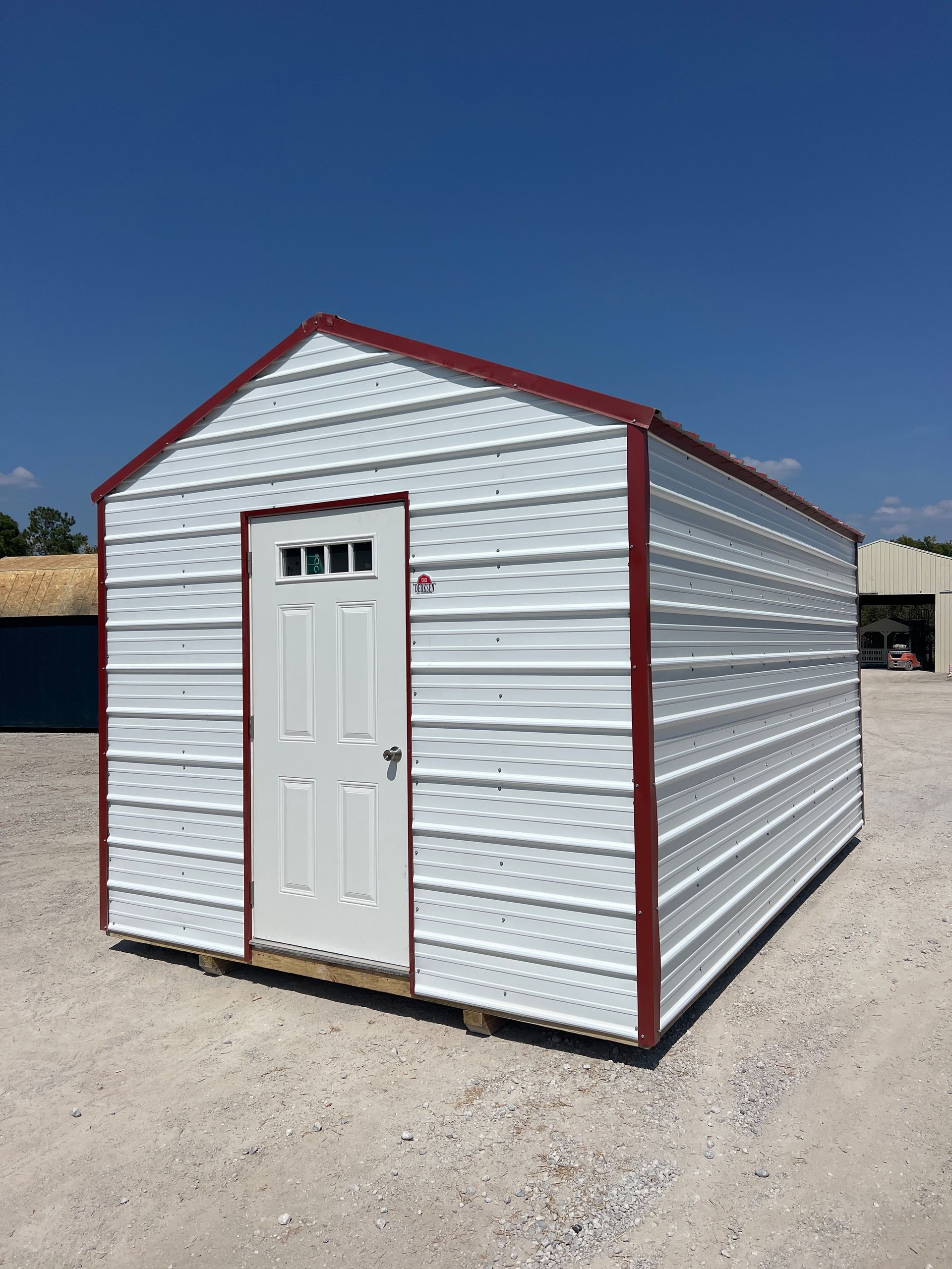 Explore the Derksen 10x16 Utility Xtra Height shed with Brilliant White siding and Rustic Red trim, perfect for all your storage needs.