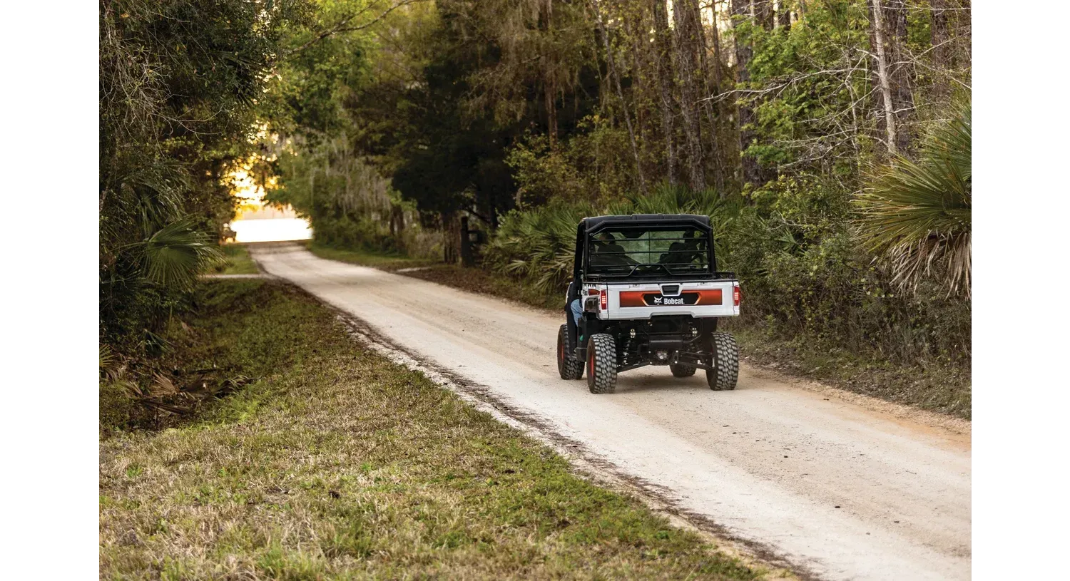 a bobcat tractor is loading rocks into a bucket