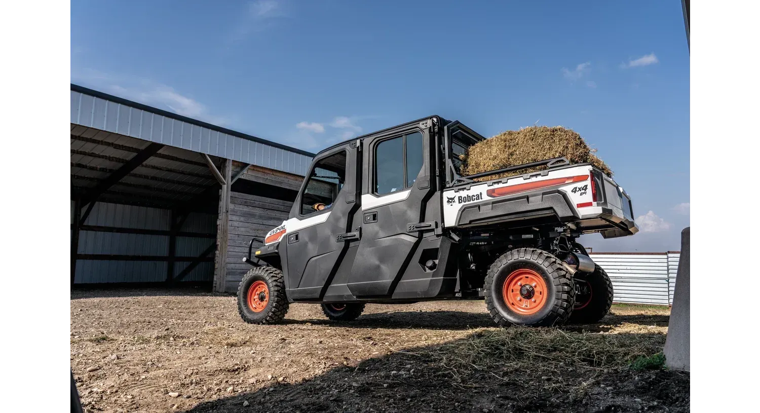 a bobcat utility truck is parked in front of a building .