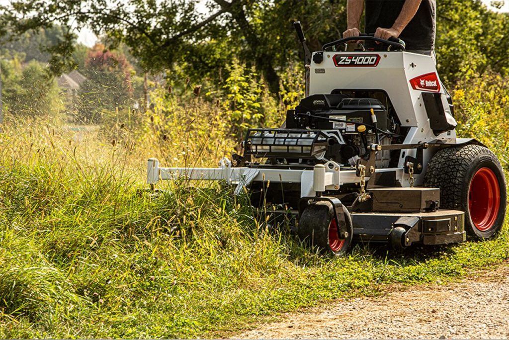 a bobcat tractor is loading rocks into a bucket