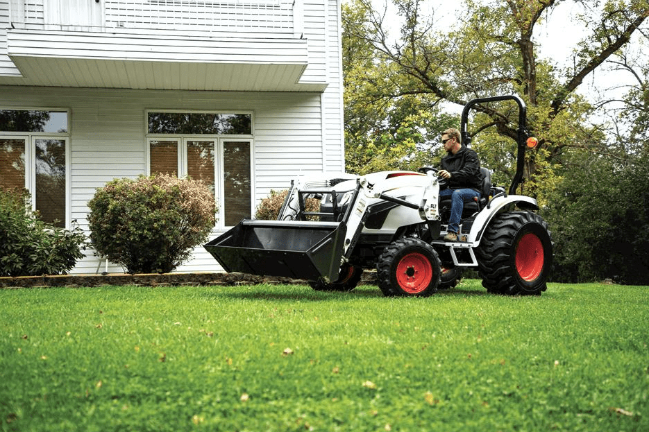 a bobcat tractor is loading rocks into a bucket