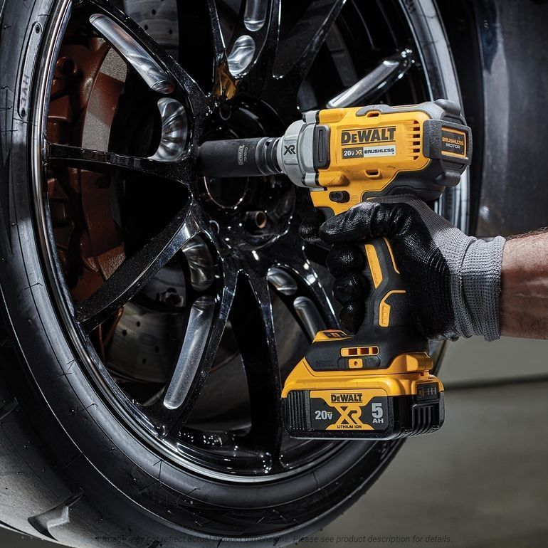 a person is using a dewalt 20v brushless impact wrench