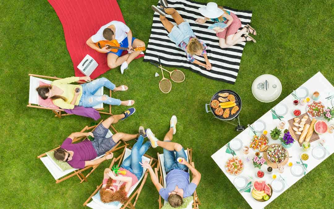 A group of people are having a picnic in the grass.