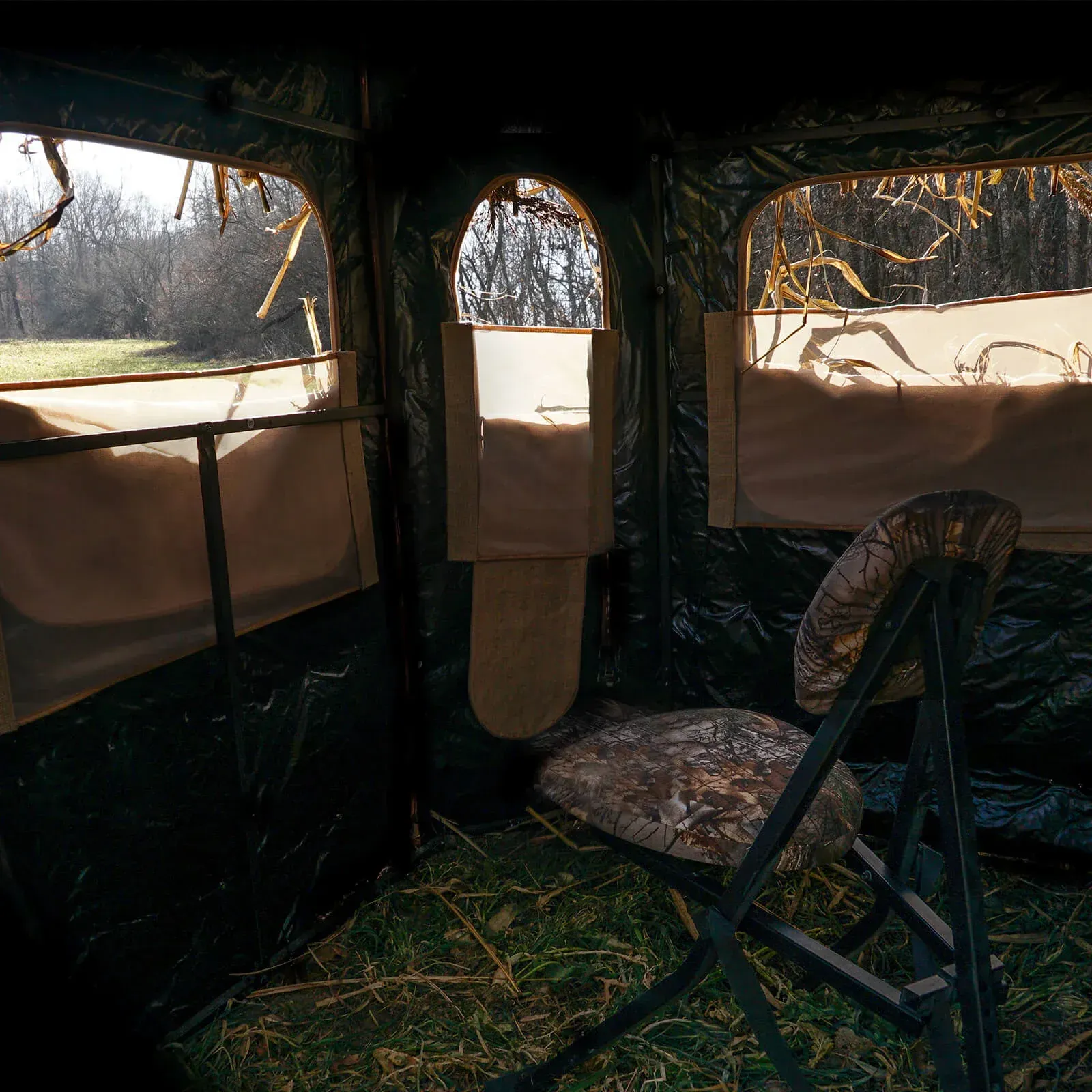 The inside of a tent with a chair and a window