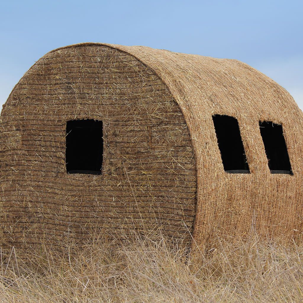 a building made out of hay with two windows
