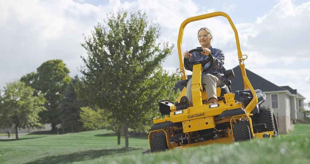 Red riding lawn mower with black seat and steering handles, shown on a white background