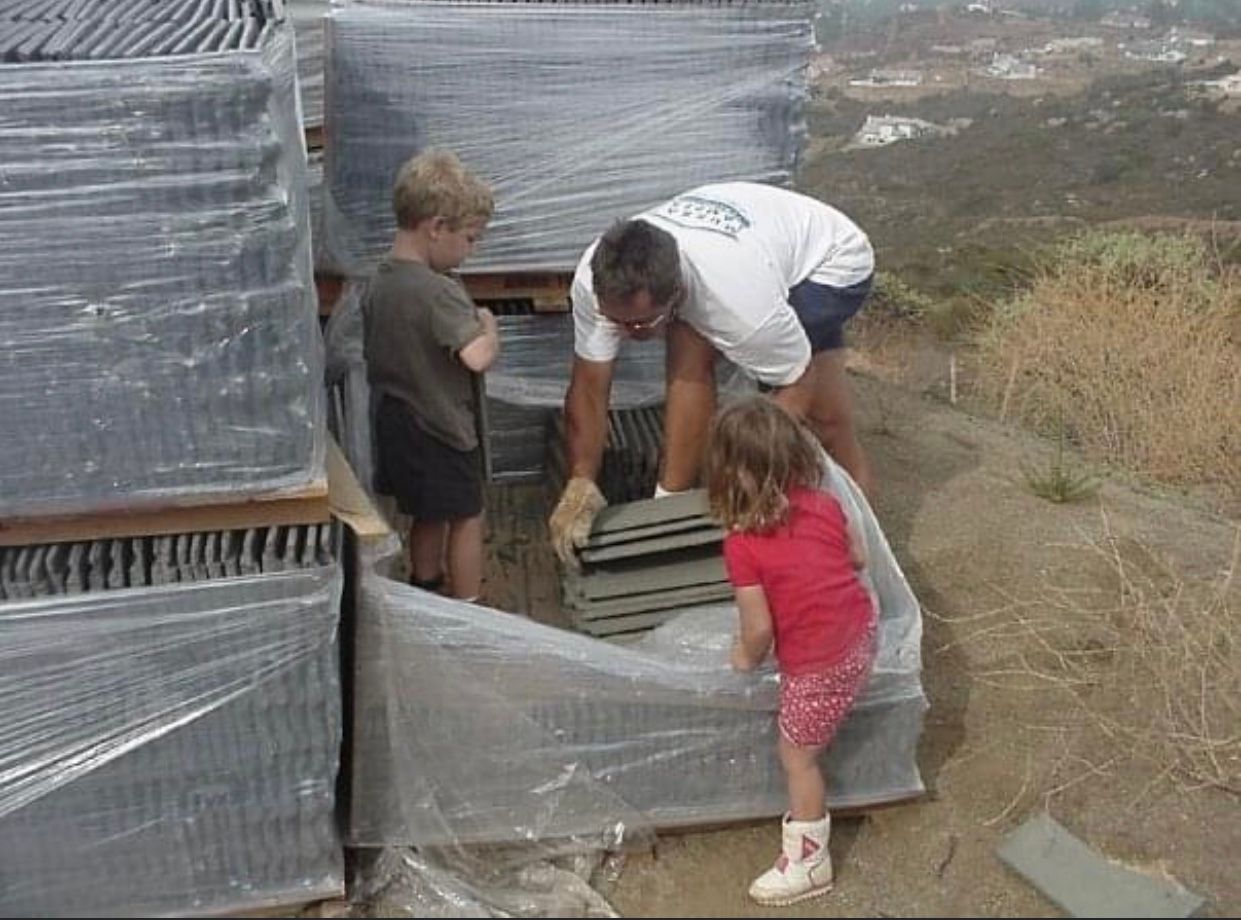 Dana, Sheridan, and Riley helping move tile