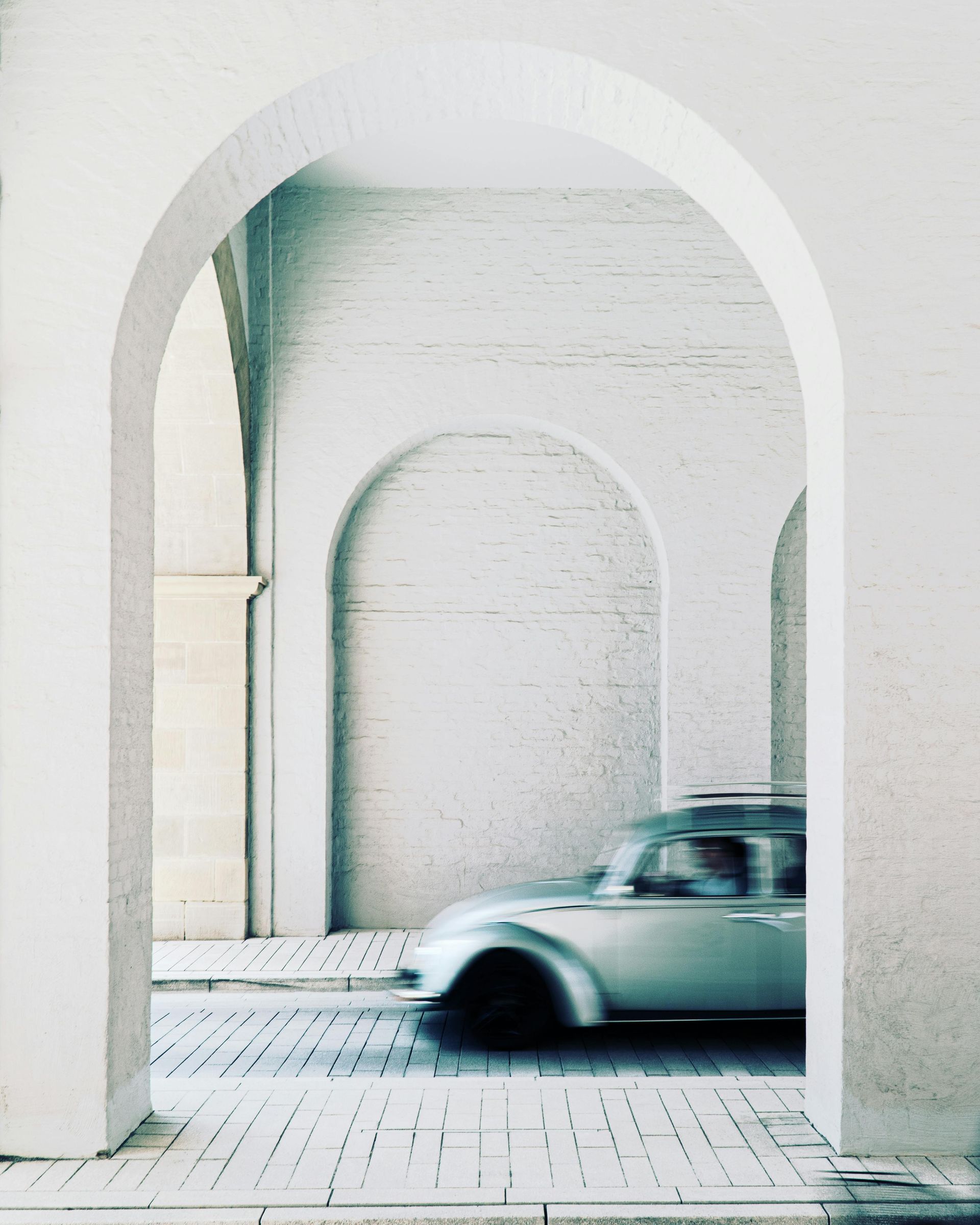 Woman relaxing on outdoor patio with wood deck and hanging chair.
