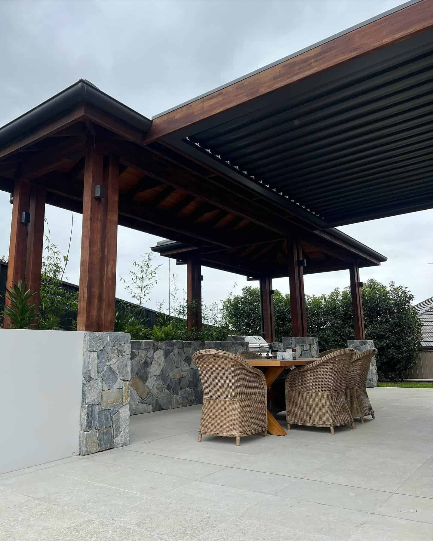 A Patio With a Table and Chairs Under a Canopy — LG Constructions in Thirroul, NSW